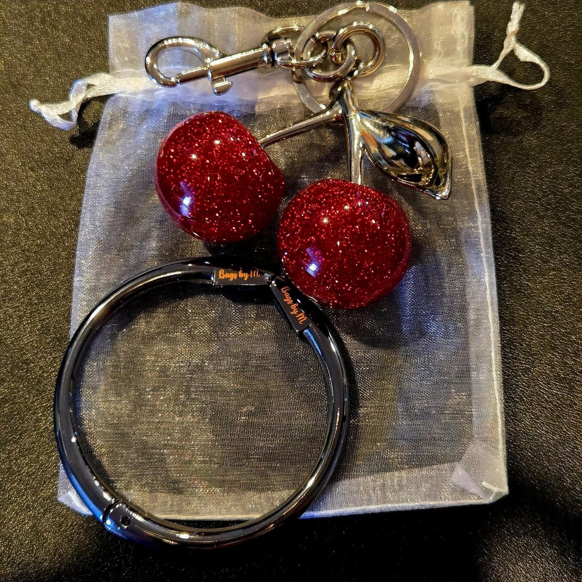 Get the Cherry charm & bag holder for $18.00 when you buy th
